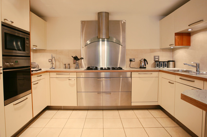 stainless steel backsplash over cooktop with stainless range hood